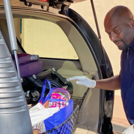 Man putting bag in trunk