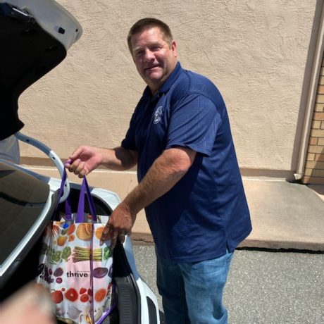 Man putting bag in trunk