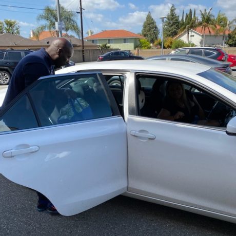 Man putting blue bag in car