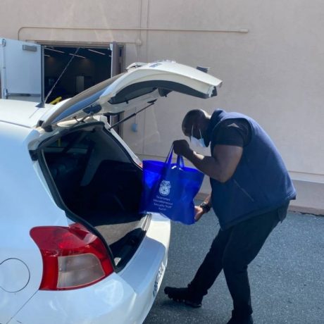 Man putting bag in trunk of car