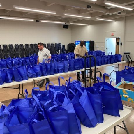 Tables with blue bags on them