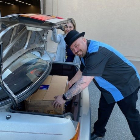 Man getting box out of trunk